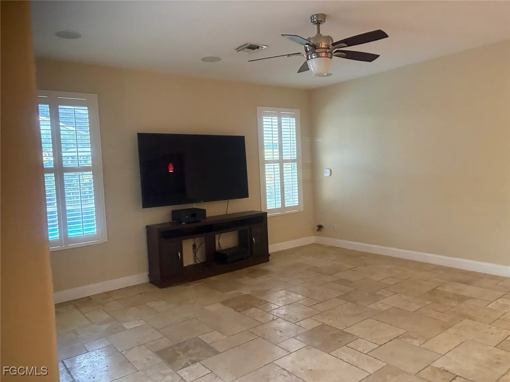 12398 Rock Ridge Lane Fort Myers, FL 33913 - Photo 19 of 43 a living room with furniture and a flat screen tv