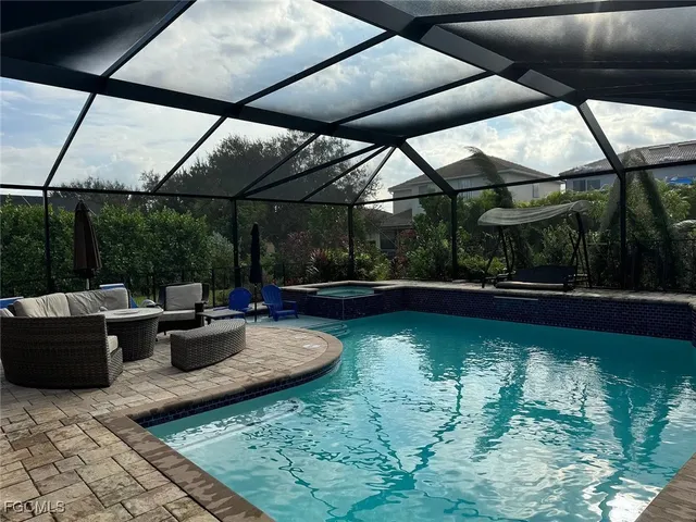 a view of swimming pool with outdoor seating