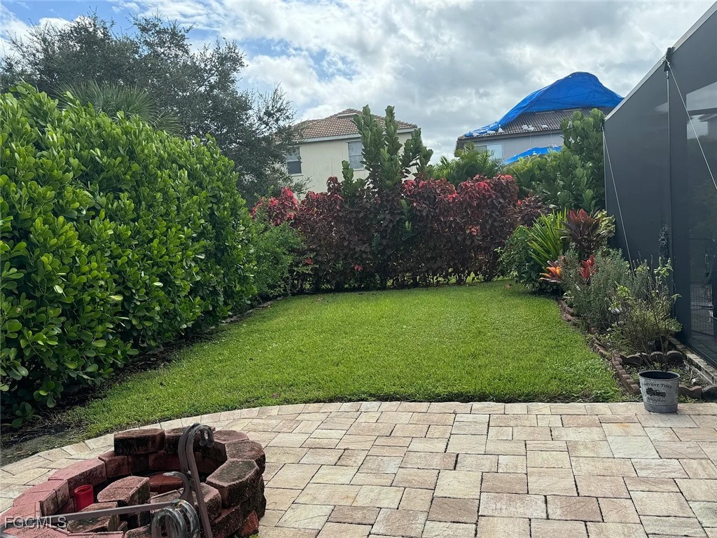 12398 Rock Ridge Lane Fort Myers, FL 33913 - Photo 38 of 43 a view of backyard with seating area and green space