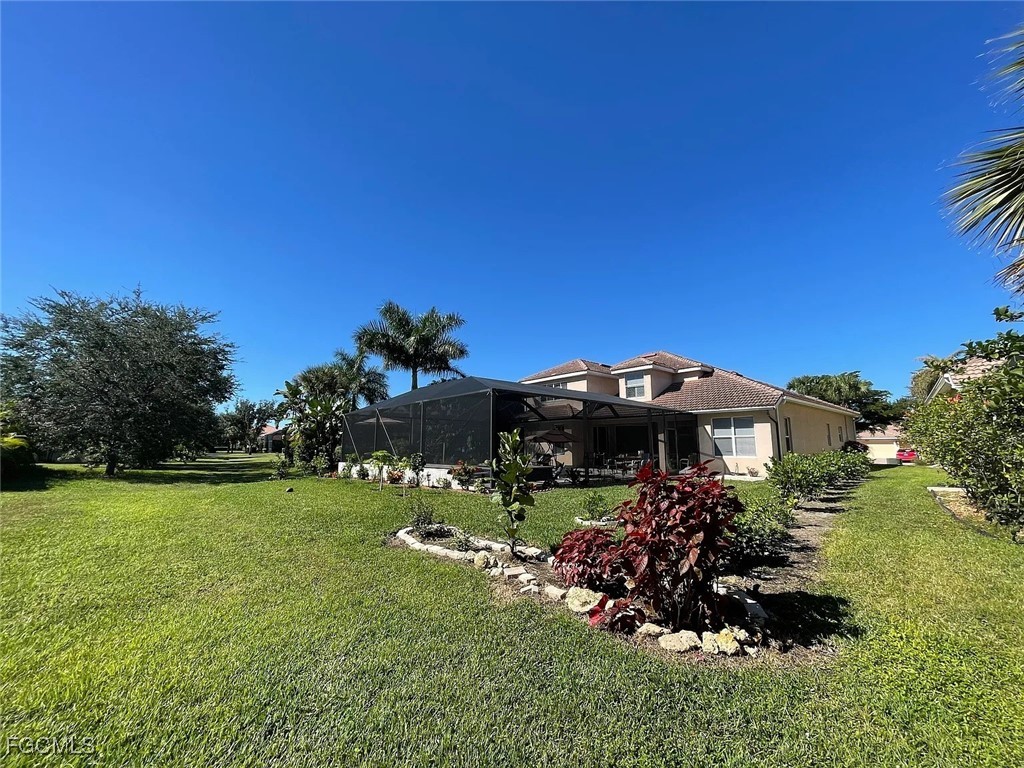 12398 Rock Ridge Lane Fort Myers, FL 33913 - Photo 40 of 43 a front view of a house with a garden