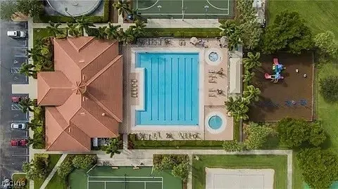 an aerial view of a house with a yard and a fountain