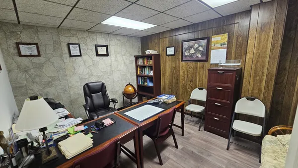 a view of a workspace with furniture