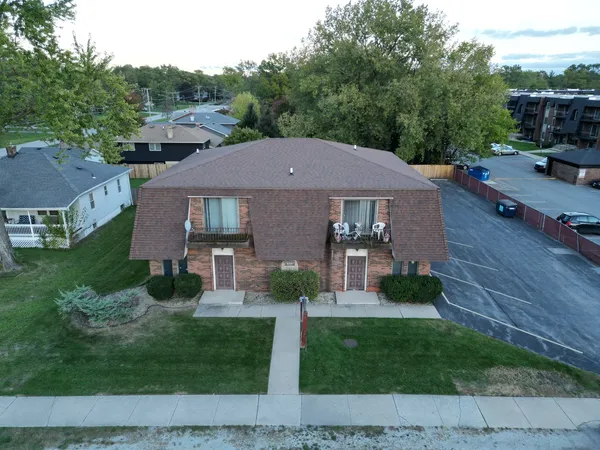 a aerial view of a house with a yard
