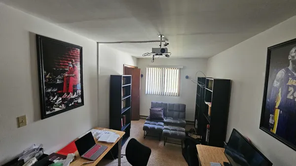 a living room with furniture windows and a flat screen tv