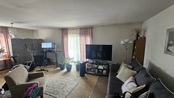 a living room with furniture and a flat screen tv