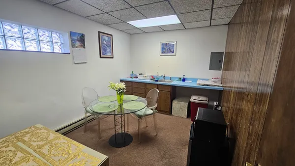 a dining room with furniture and wooden floor