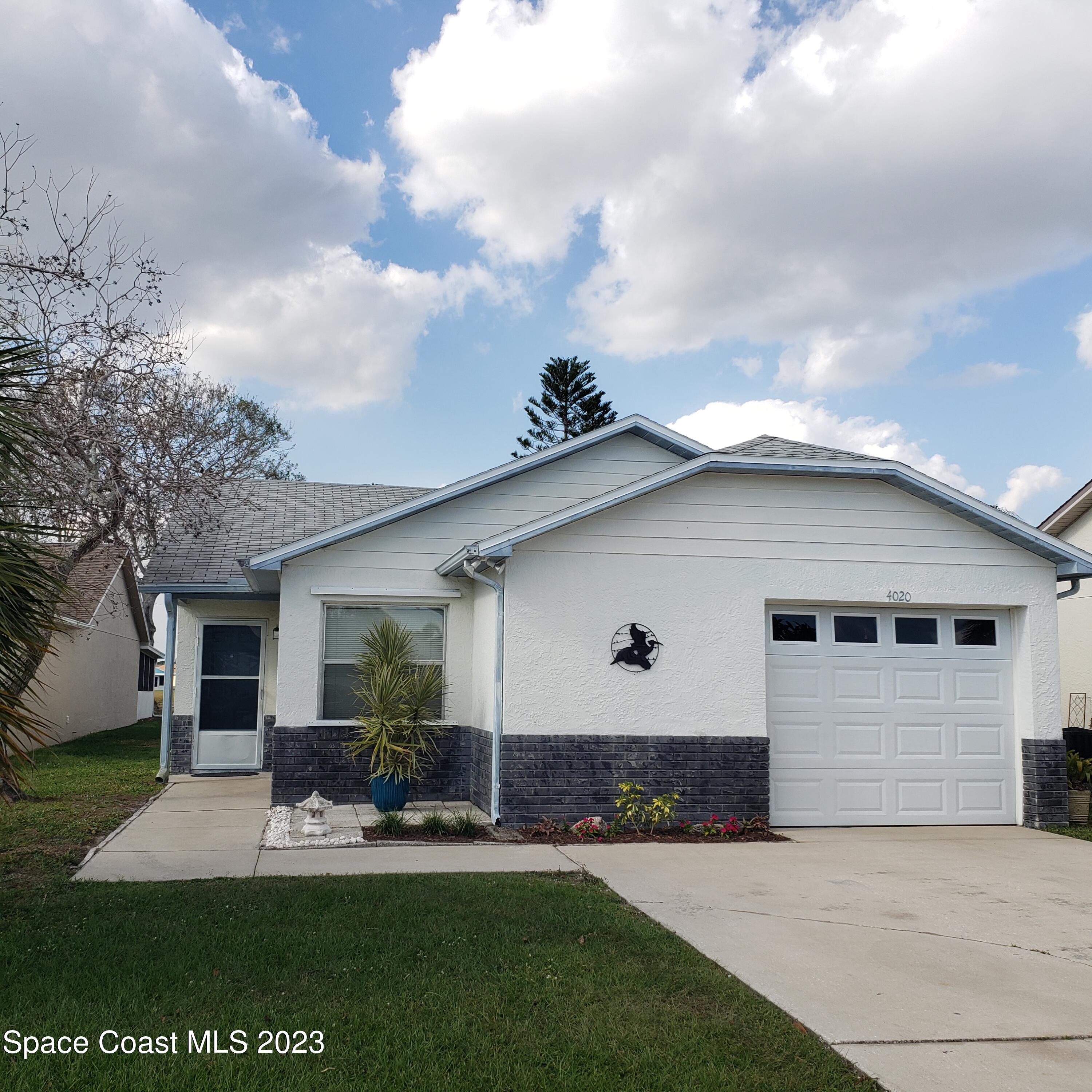 4020 Bayberry Drive Melbourne, FL 32901 - Photo 1 of 26 a front view of house with yard and green space