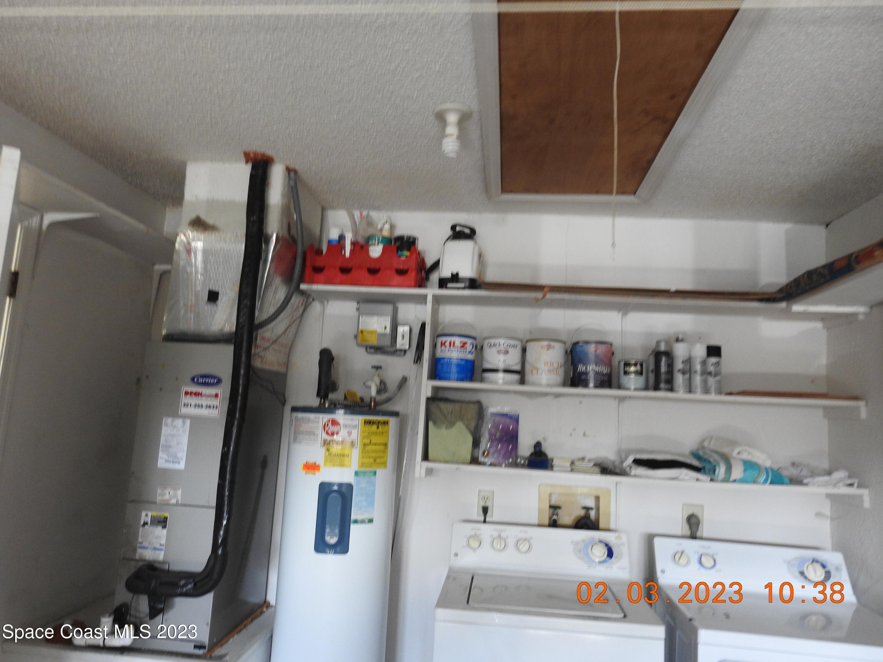 4020 Bayberry Drive Melbourne, FL 32901 - Photo 16 of 26 a utility room with lots of clutter and cabinets