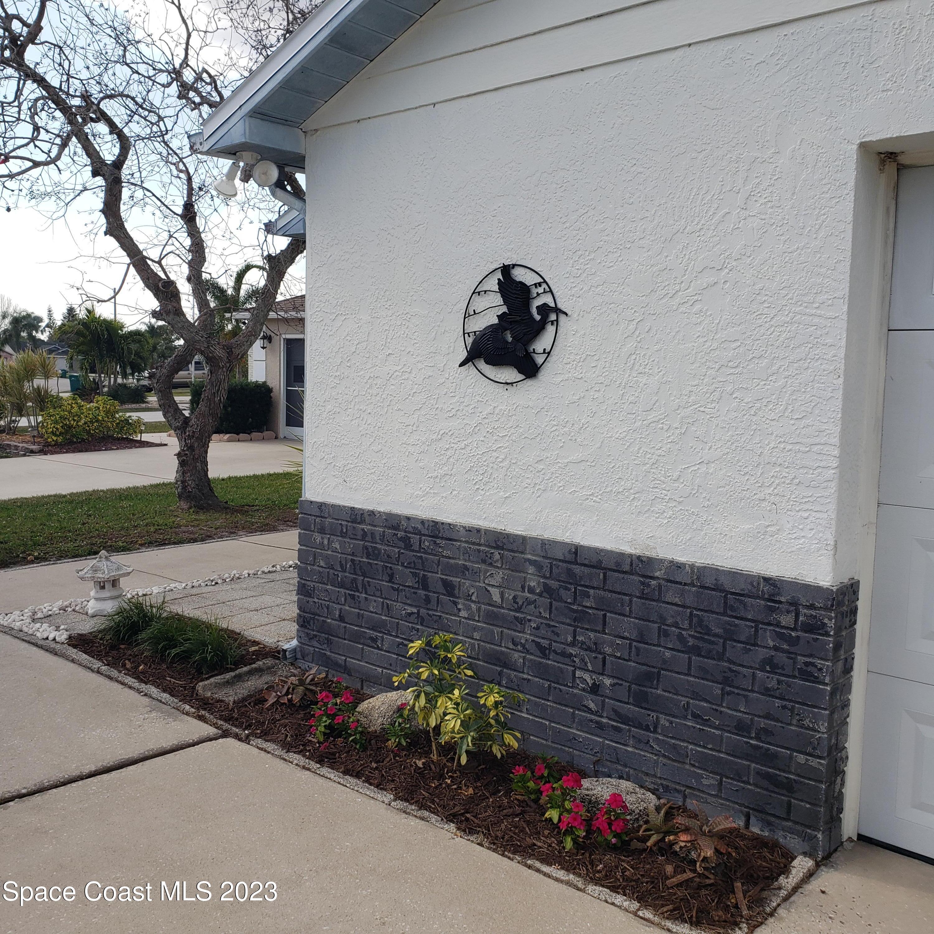 4020 Bayberry Drive Melbourne, FL 32901 - Photo 3 of 26 a front view of a house with a yard