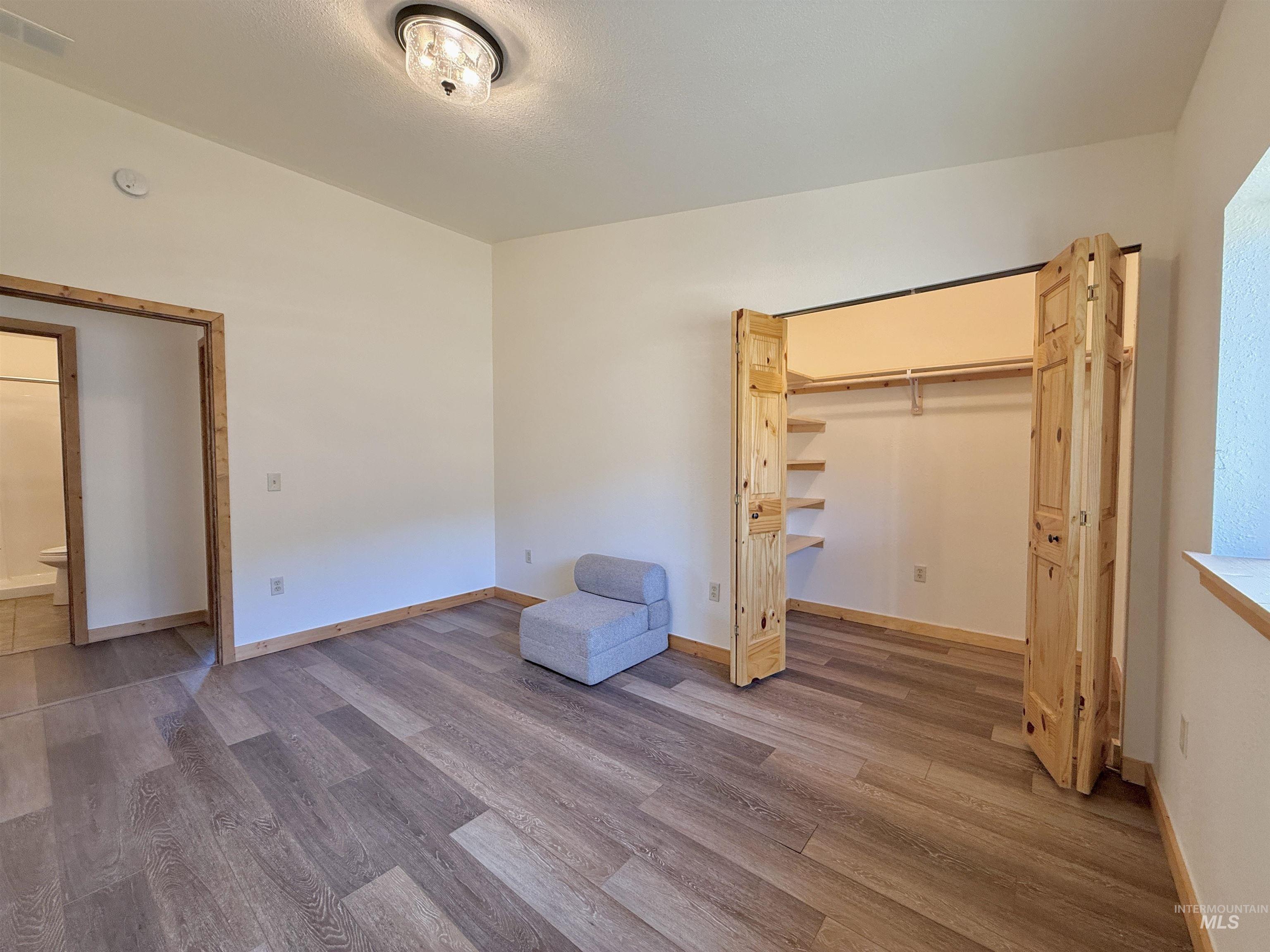 150 Buck Boulevard White Bird, ID 83554 - Photo 13 of 45 Unfurnished bedroom featuring wood finished floors and baseboards