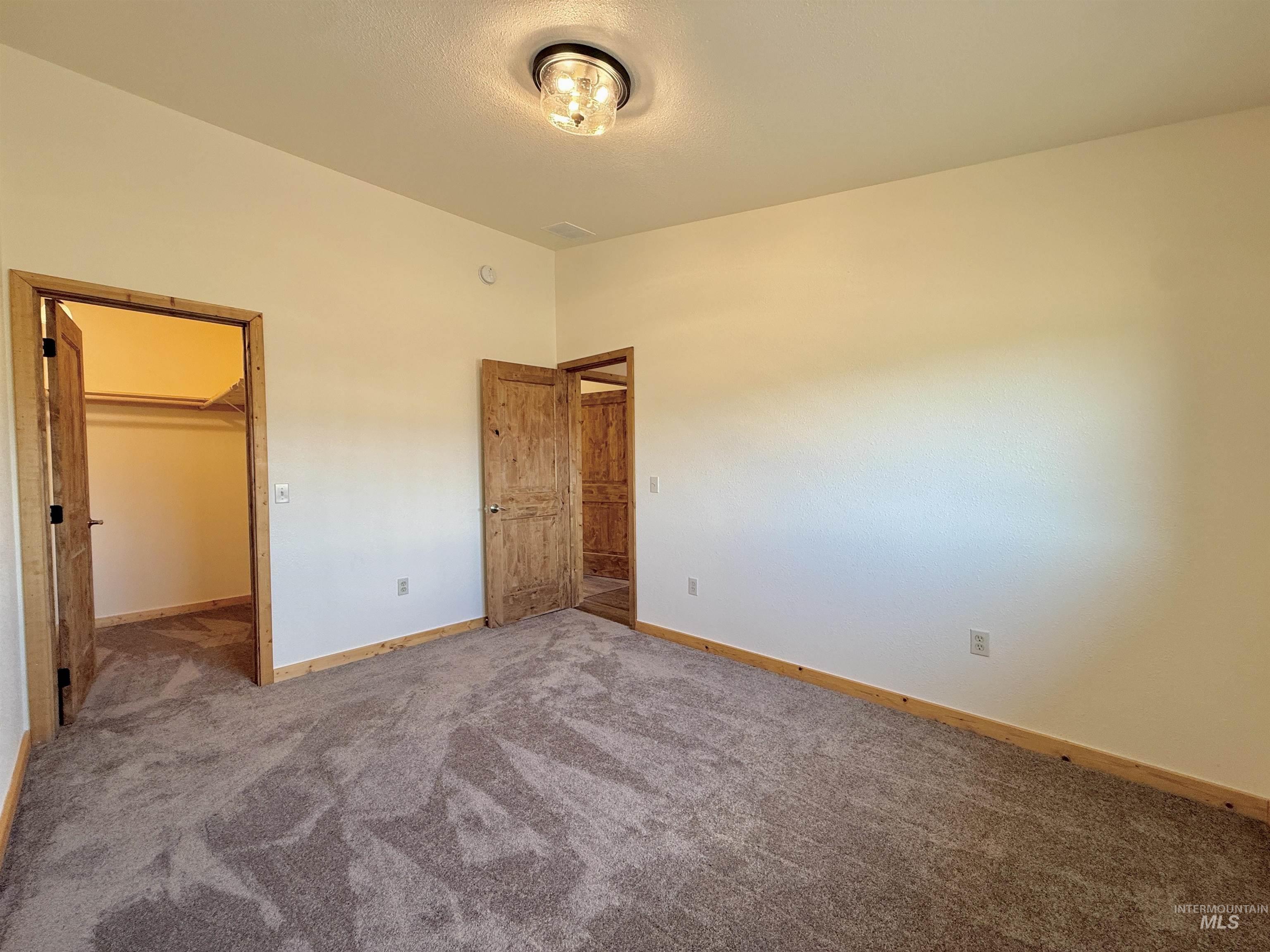 150 Buck Boulevard White Bird, ID 83554 - Photo 16 of 45 Unfurnished bedroom with carpet flooring and a spacious closet
