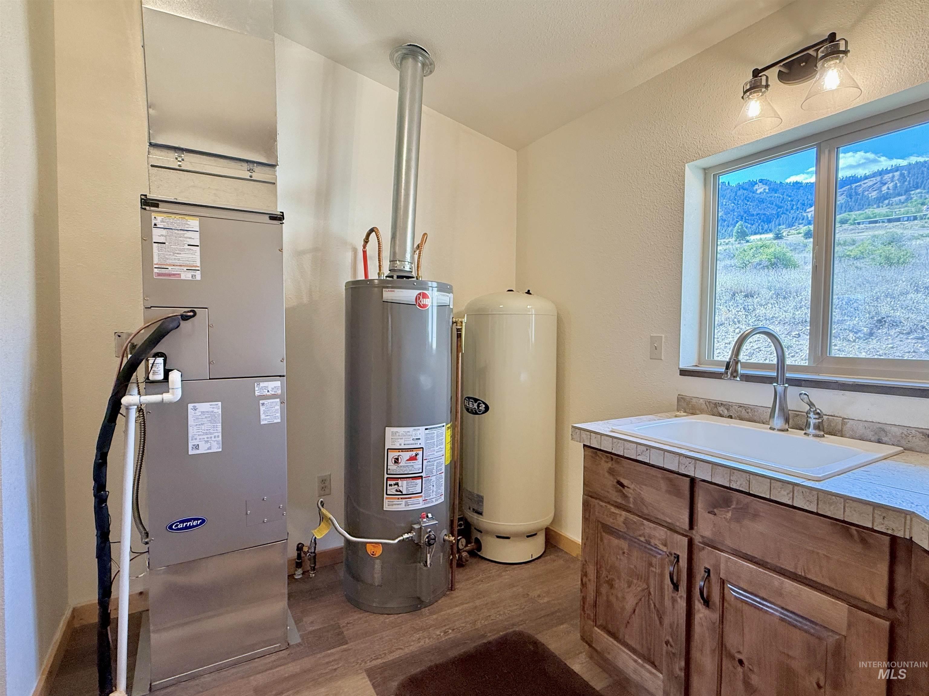 150 Buck Boulevard White Bird, ID 83554 - Photo 25 of 45 Utility room with water heater and heating unit