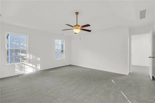 a view of a backyard with wooden fence and trees