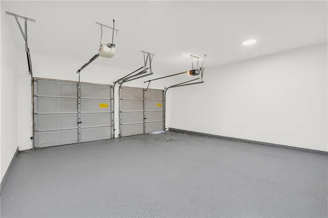 a view of a yard with plants and trees