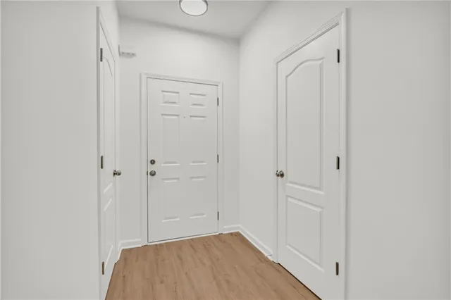a view of a livingroom with wooden floor and a ceiling fan