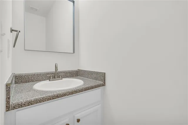 a kitchen with stainless steel appliances kitchen island granite countertop a refrigerator and a stove top oven