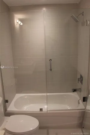 a bathroom with a shower and a toilet