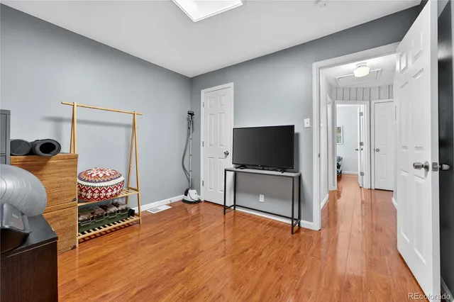 a bedroom with furniture and a flat screen tv