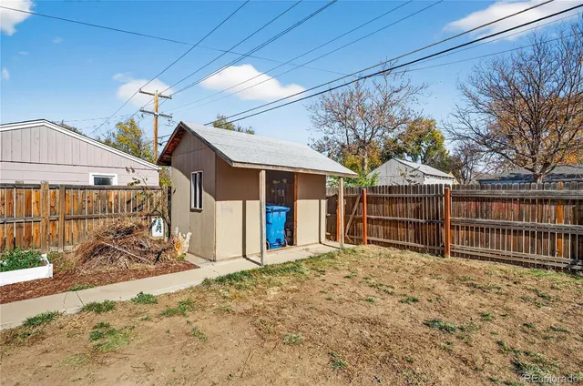 a view of a house with wooden fence