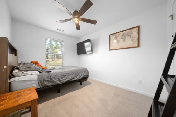 a bedroom with bed and a window