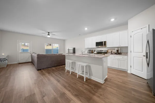 a kitchen with stainless steel appliances a refrigerator and a stove top oven