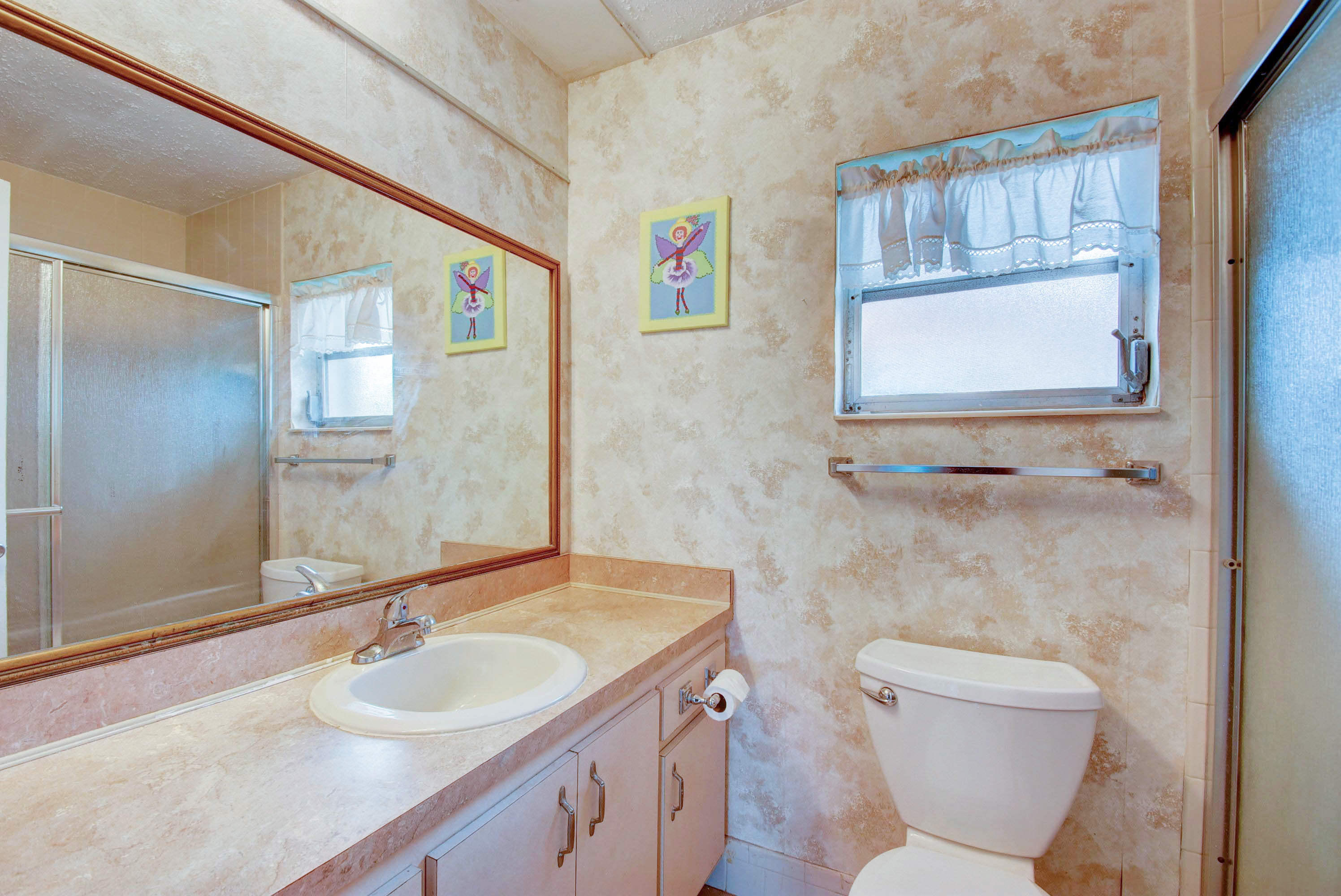 6295 Dusenburg Road Delray Beach, FL 33484 - Photo 23 of 34 a bathroom with a toilet sink and mirror
