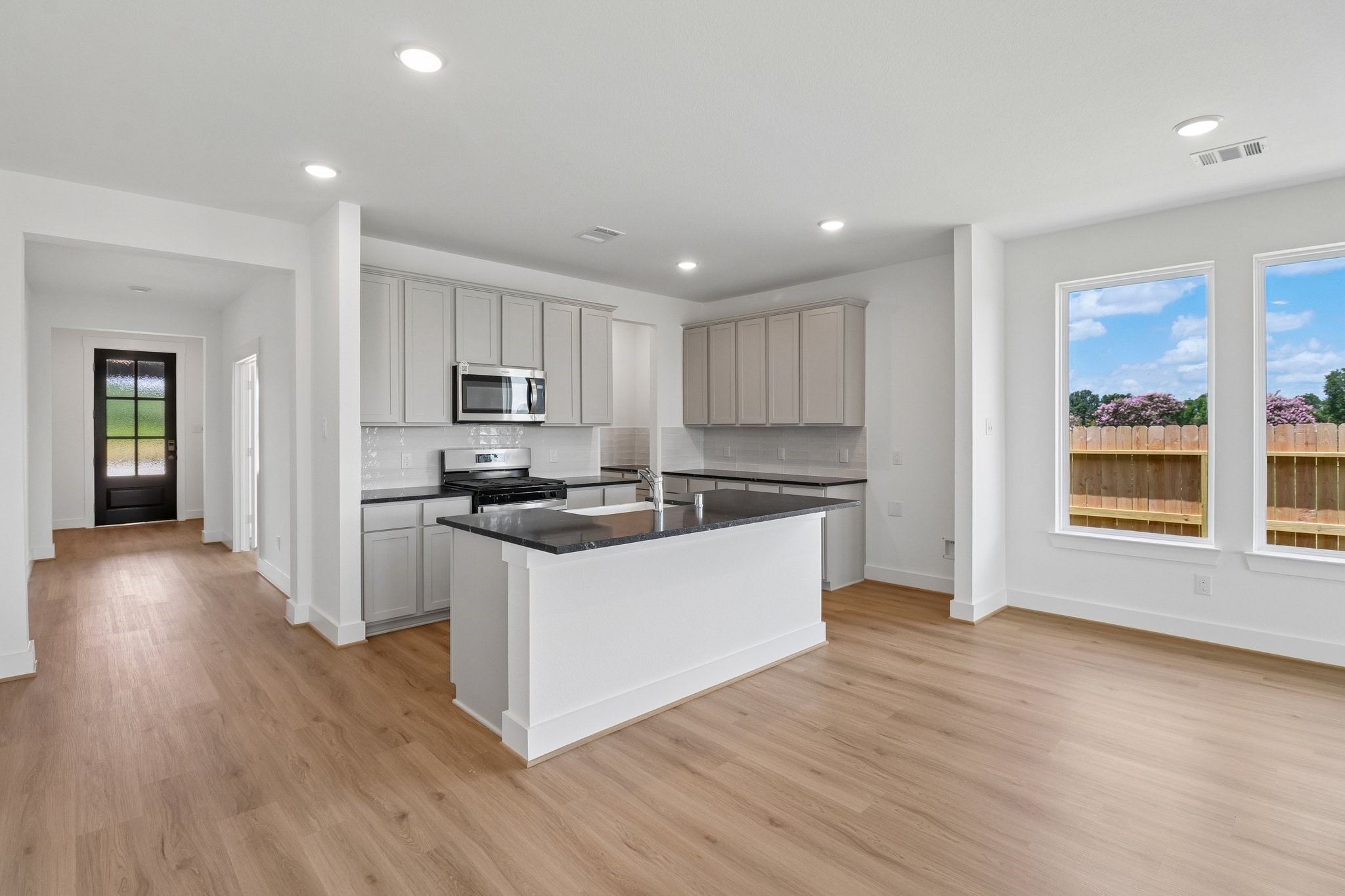 5314 Grace Sunshine Spring Spring, TX 77379 - Photo 7 of 27 Natural light pours in through large windows, creating a bright and airy atmosphere that makes cooking feel less like a chore and more like a delightful experience.