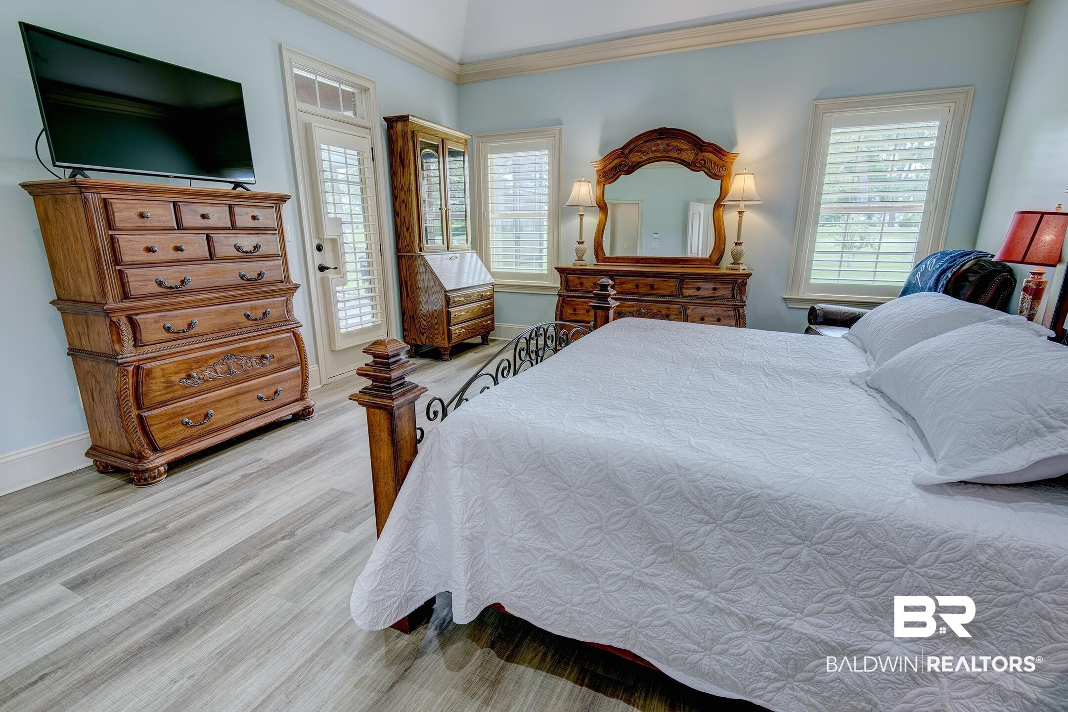 9357 Lakeview Drive Foley, AL 36535 - Photo 43 of 68 Spacious bedroom featuring light wood-finish flooring, a vaulted ceiling, and multiple windows with plantation shutters