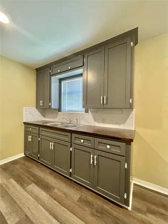 a spacious bathroom with a granite countertop sink and a mirror