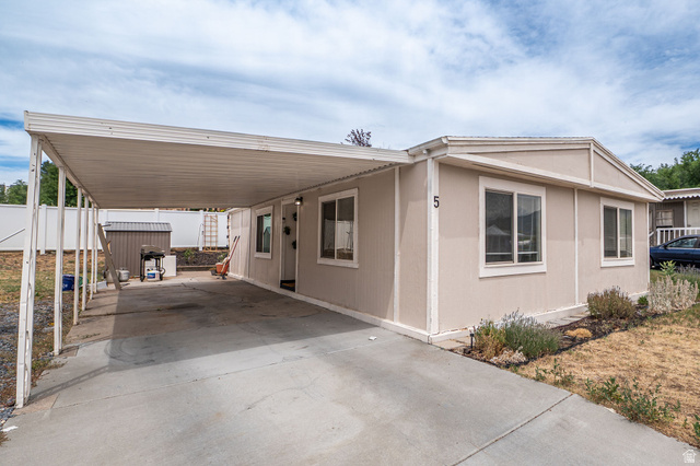 2600 North Hill Field Road, Unit 5 Layton, UT 84041 - Photo 25 of 33 Exterior featuring a covered carport, light-colored siding, and multiple windows