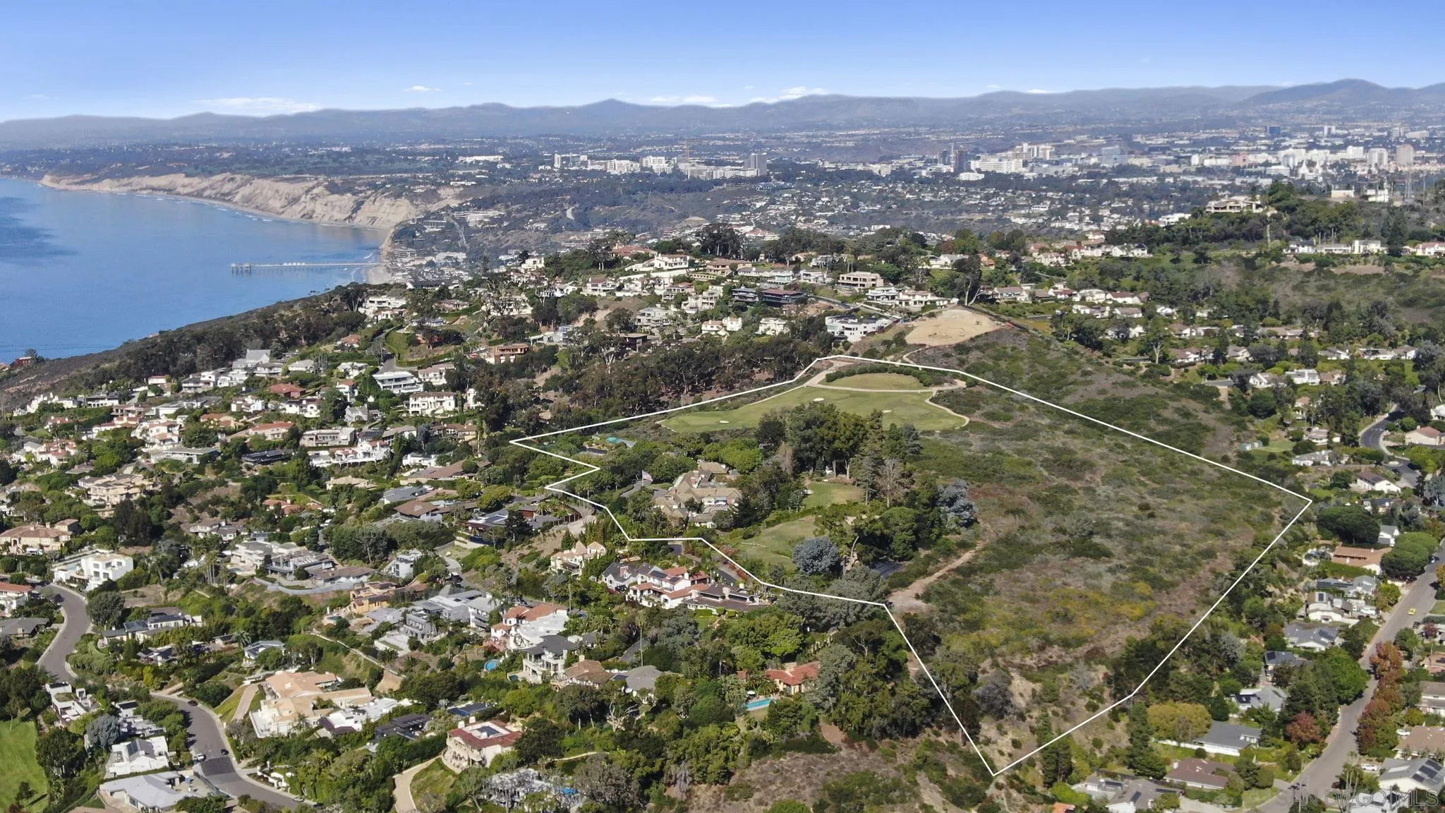 7007 Country Club Drive La Jolla, CA 92037 - Photo 2 of 9 an aerial view of house with yard and mountain view in back