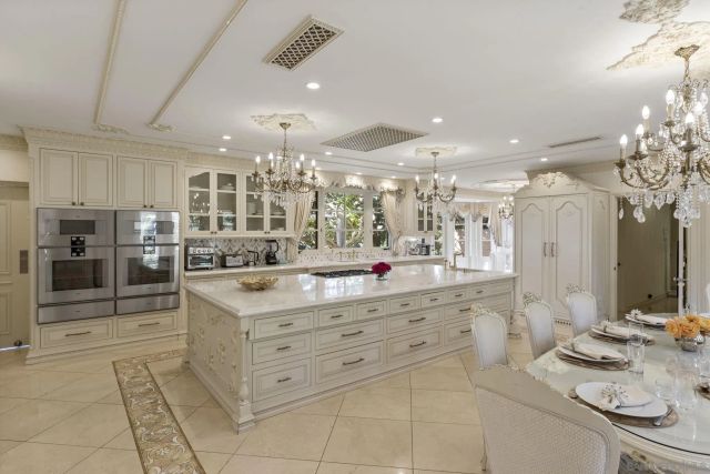a kitchen with stainless steel appliances kitchen island granite countertop a sink and cabinets