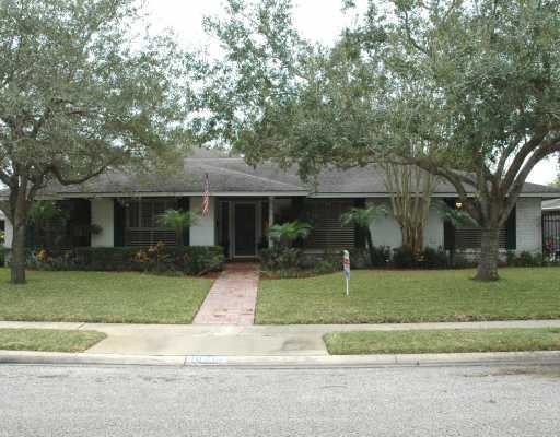 a white house that has a tree in front of it