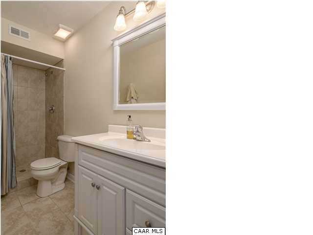 1711 Old Forge Road Charlottesville, VA 22901 - Photo 15 of 18 a bathroom with a granite countertop sink a toilet and a mirror