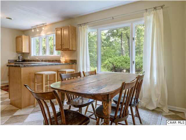 1711 Old Forge Road Charlottesville, VA 22901 - Photo 6 of 18 a kitchen with a table chairs and wooden floor