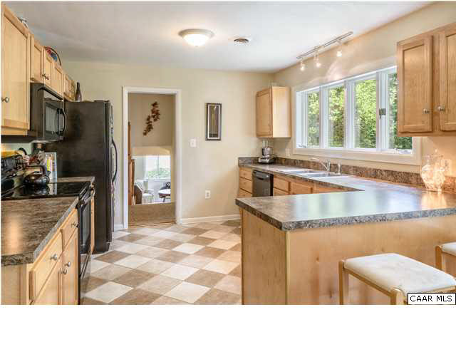 1711 Old Forge Road Charlottesville, VA 22901 - Photo 7 of 18 a kitchen with granite countertop a stove a sink and a refrigerator