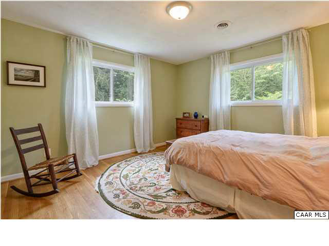 1711 Old Forge Road Charlottesville, VA 22901 - Photo 8 of 18 a bedroom with a bed a chair and a window
