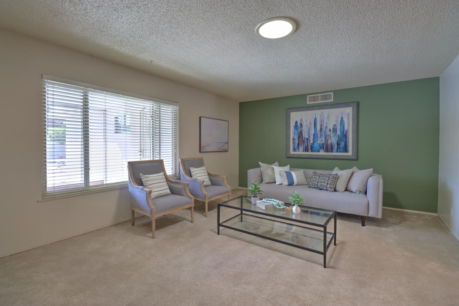 6265 North Colonial Avenue Fresno, CA 93704 - Photo 5 of 22 a living room with furniture and a large window