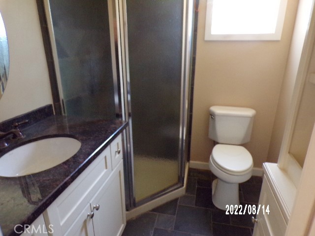 13425 Jensen Road Clearlake Oaks, CA 95423 - Photo 14 of 17 a bathroom with a toilet sink and mirror