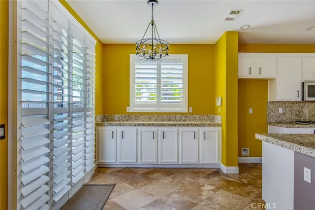 a bathroom with a granite countertop window and a shower