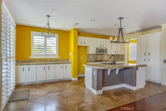 a kitchen with stainless steel appliances granite countertop a sink and a stove