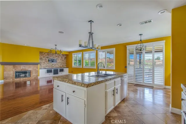 a kitchen with stainless steel appliances granite countertop a sink and a stove