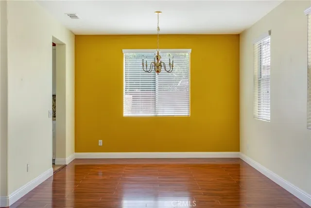 a view of a room with wooden floor and windows