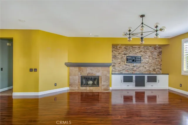 a view of a living room with a table and a fireplace