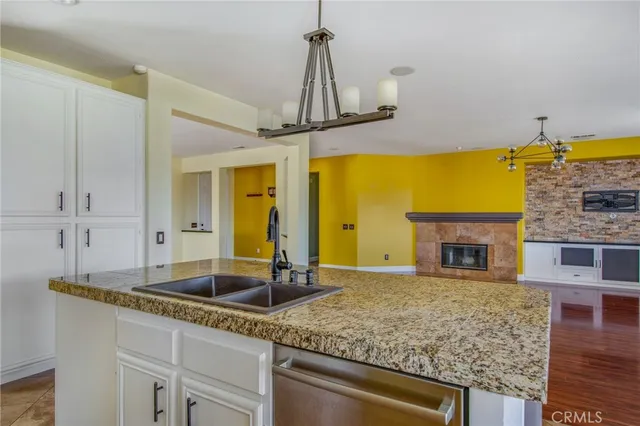 a kitchen with sink cabinet and large mirror