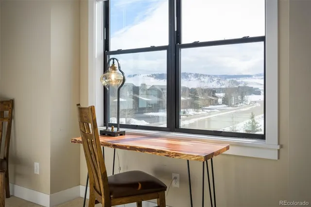 a view of a room with a window and furniture