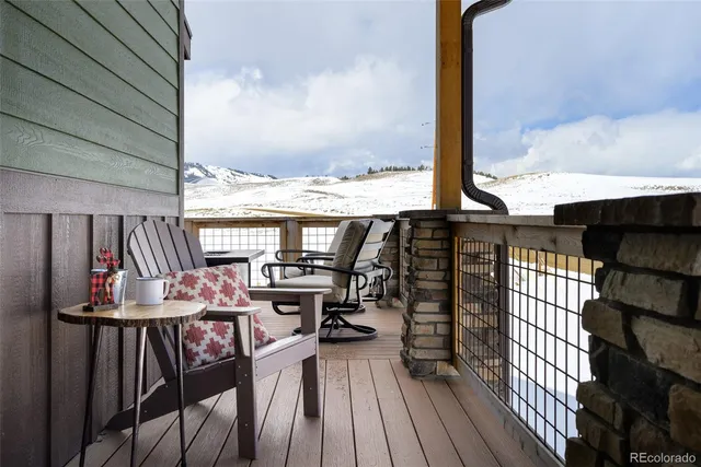 a view of a balcony with chairs and wooden floor