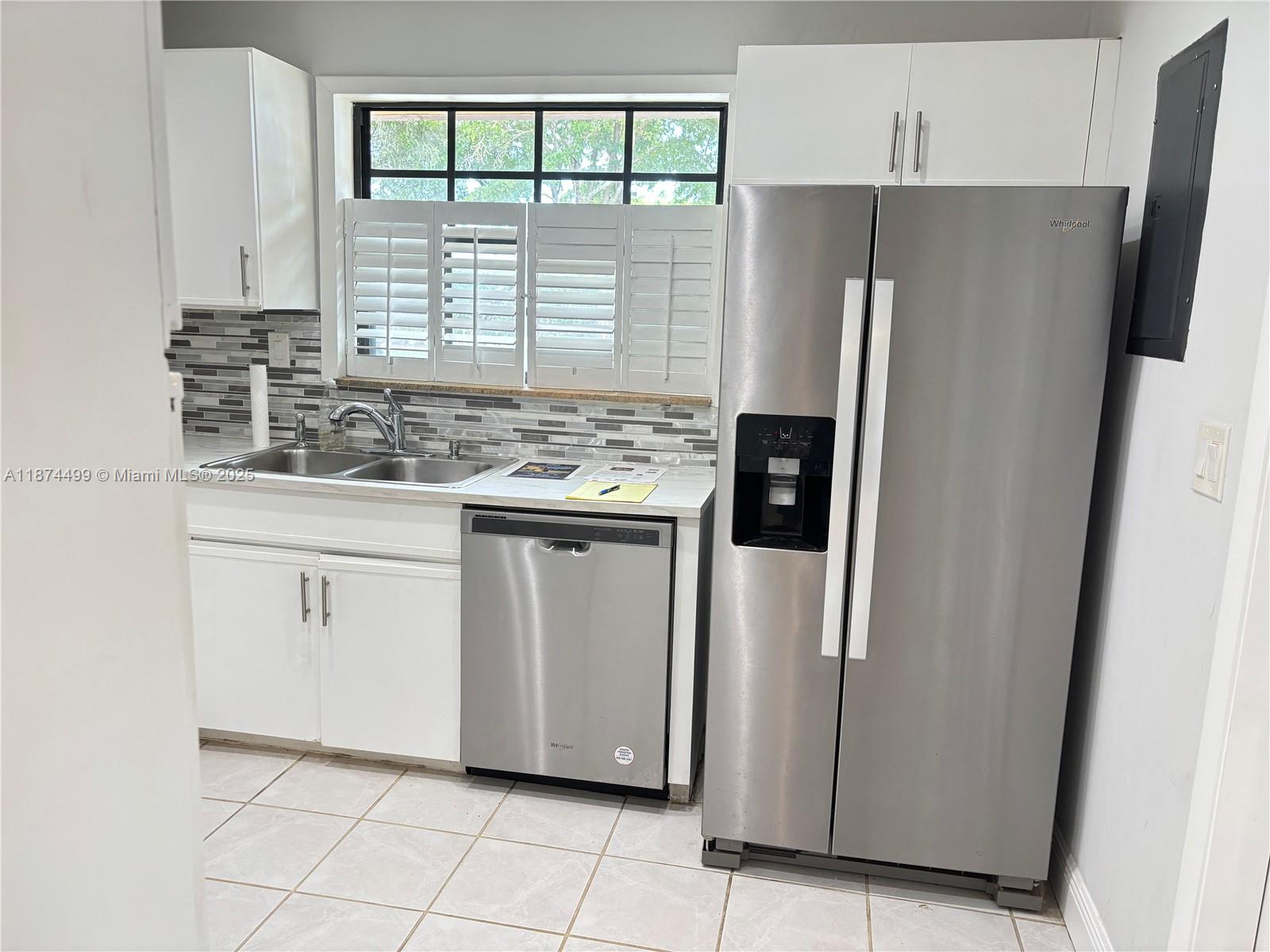 13231 Southwest 114th Terrace Miami, FL 33186 - Photo 6 of 25 a kitchen with stainless steel appliances a refrigerator sink and cabinets