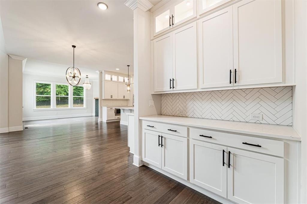 947 Hunter Way Milton, GA 30004 - Photo 21 of 78 a kitchen with stainless steel appliances granite countertop white cabinets and window