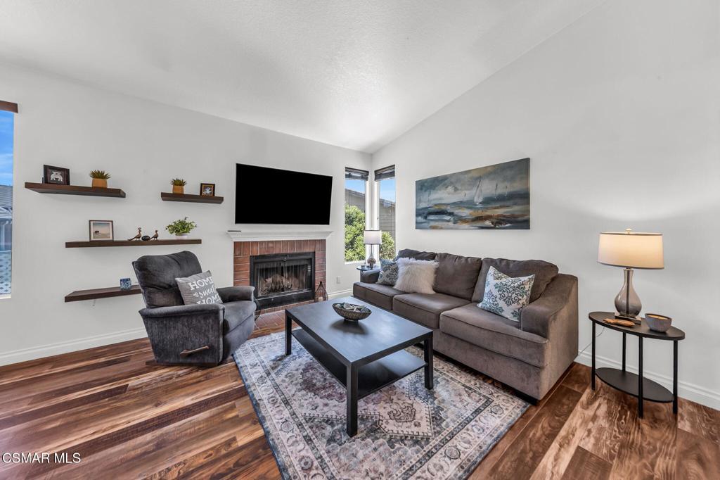 2450 Pleasant Way, Unit N Thousand Oaks, CA 91362 - Photo 3 of 39 a living room with furniture a fireplace and a flat screen tv
